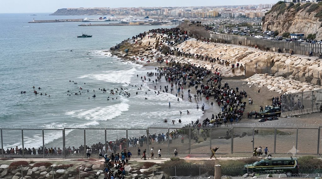Migrants attempting to cross the border into Ceuta, Spain