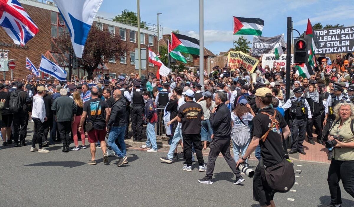 Protesters gathered outside a building in the UK holding signs