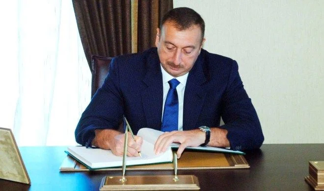 President of Azerbaijan Ilham Aliyev signing documents