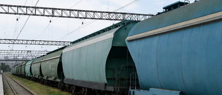 Freight train carrying cargo along railway tracks