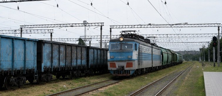 Freight train carrying cargo along railway tracks