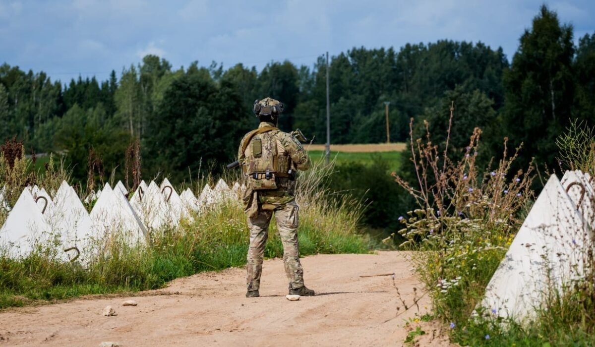 Border guard patrol near dragon's teeth anti-tank obstacles in the Piedruja area.