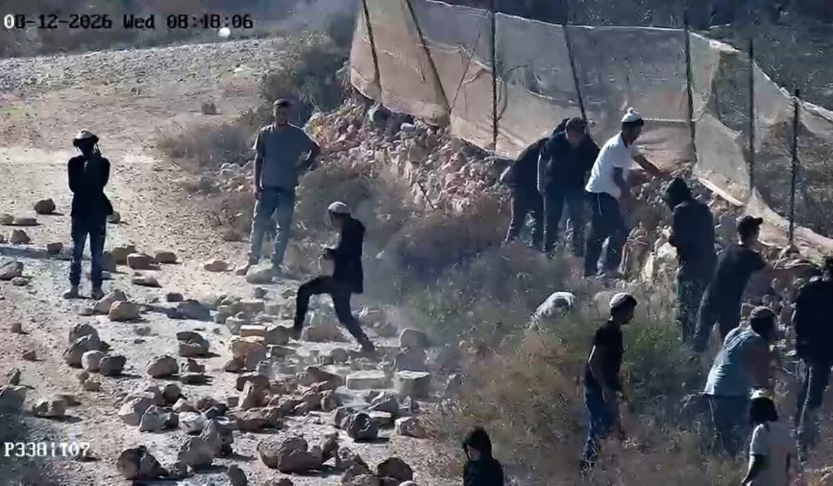 A group of individuals on a country road in the village of Qusra, August 12, 2026.