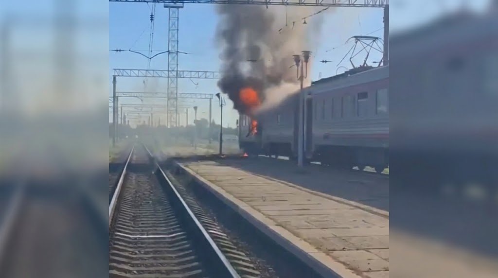 Passenger train carriages stopped along railway tracks near a shelter in Ukraine